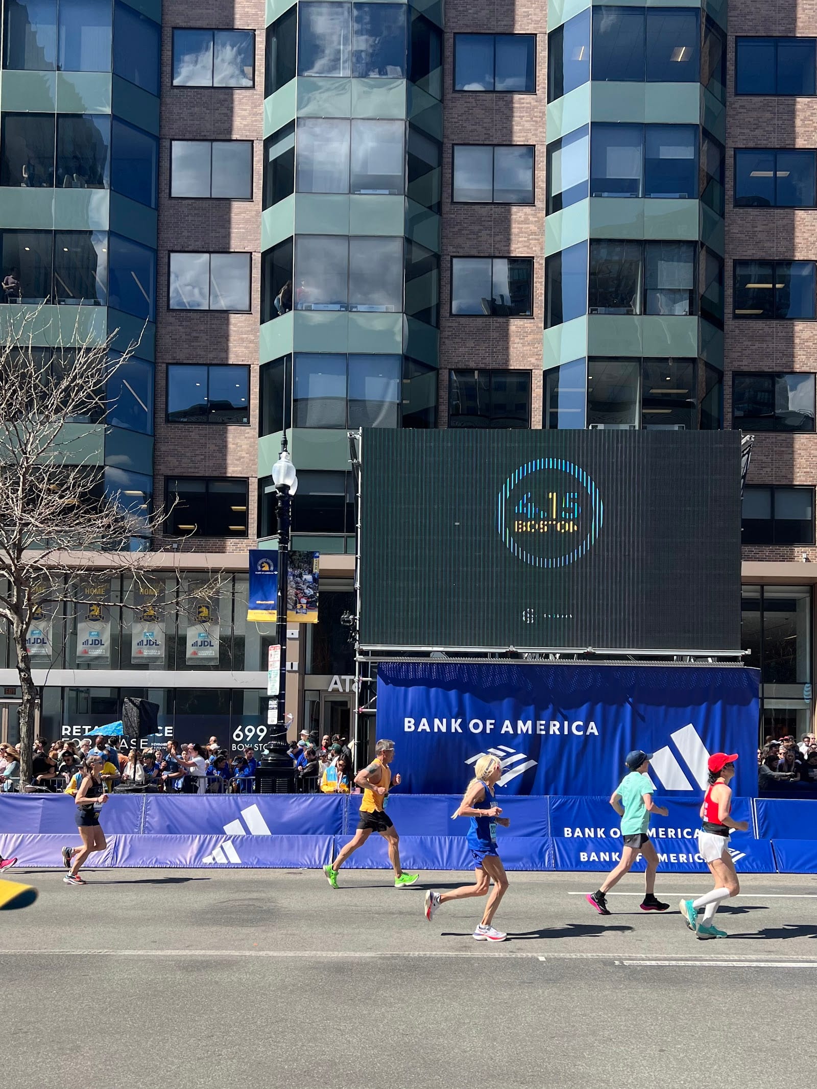 Runners crossing the finish line at the Boston Marathon in Copley Square.