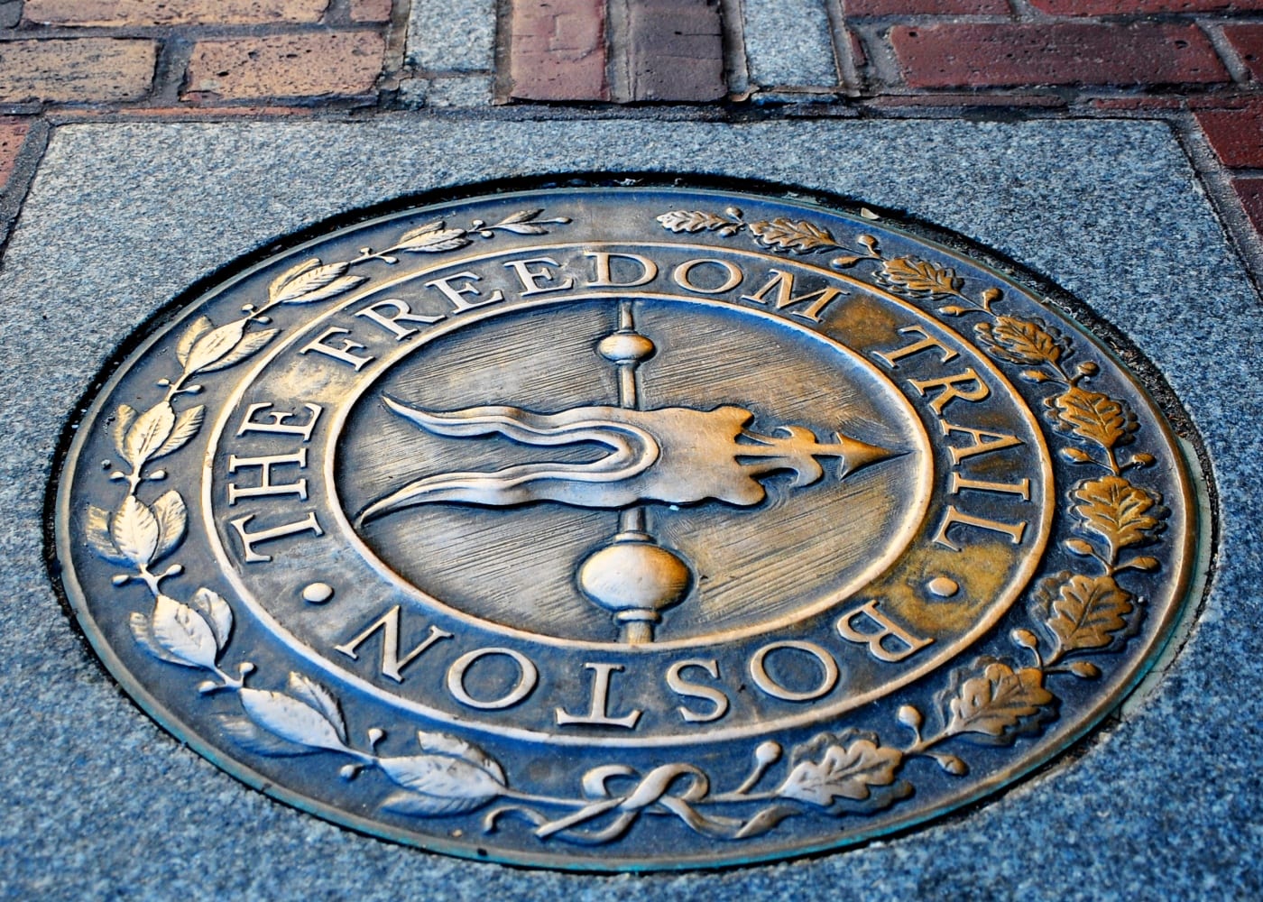 The red-brick Freedom Trail line leading through downtown Boston past historic buildings.