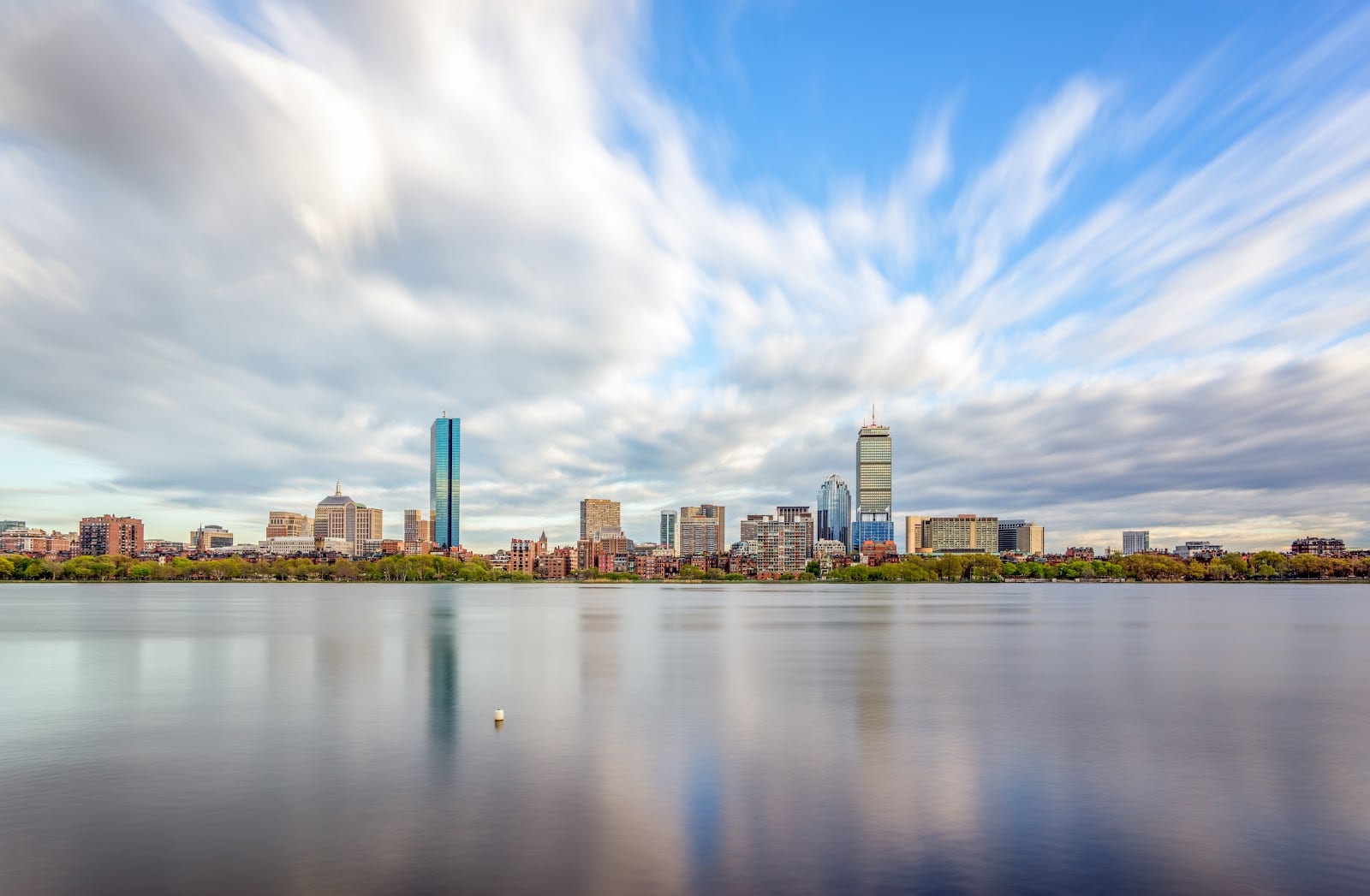 The Charles River with the Boston skyline and sailboats in the distance.