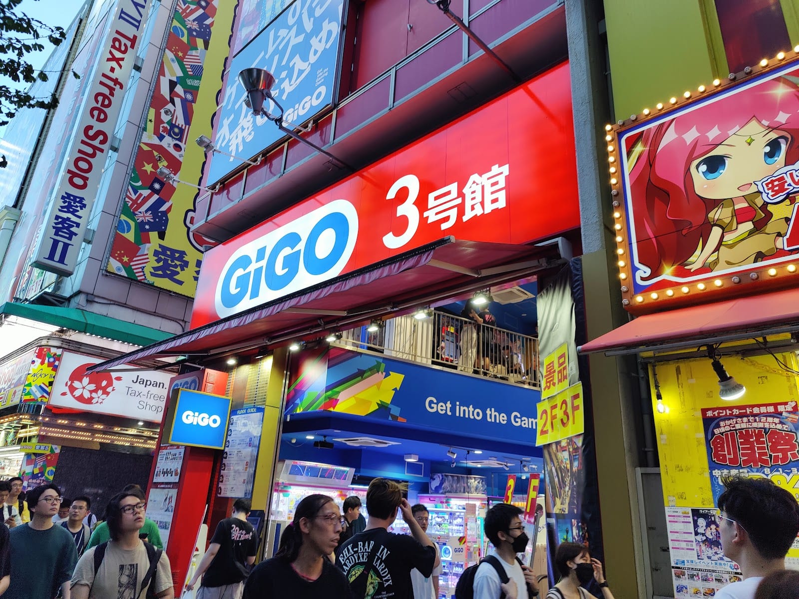 Crowds on an Akihabara side street past a neon GiGO arcade sign.