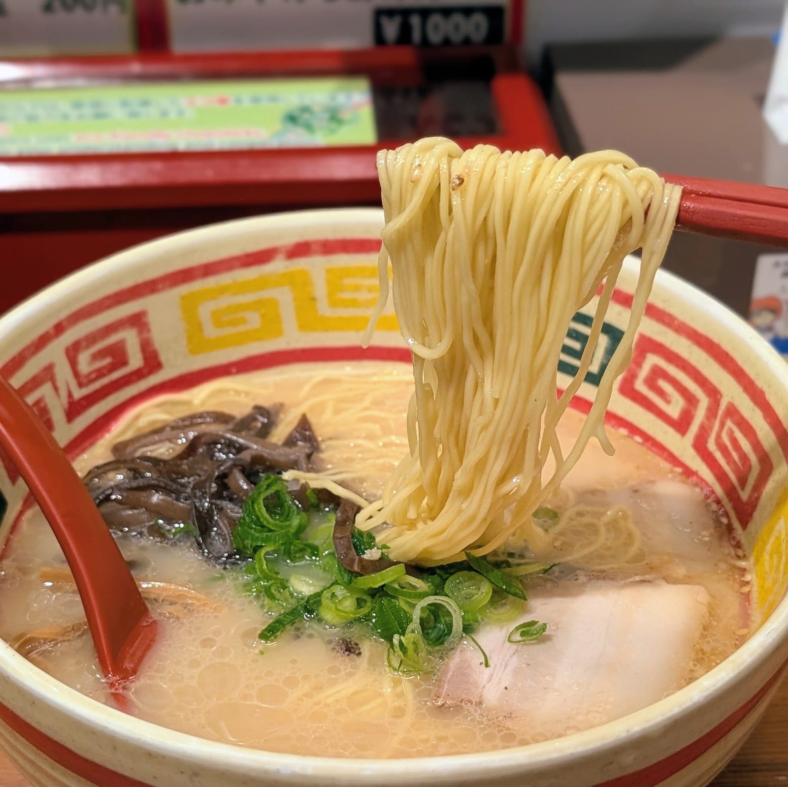 A noodle lift from a bowl of Kyushu Jangara tonkotsu ramen.