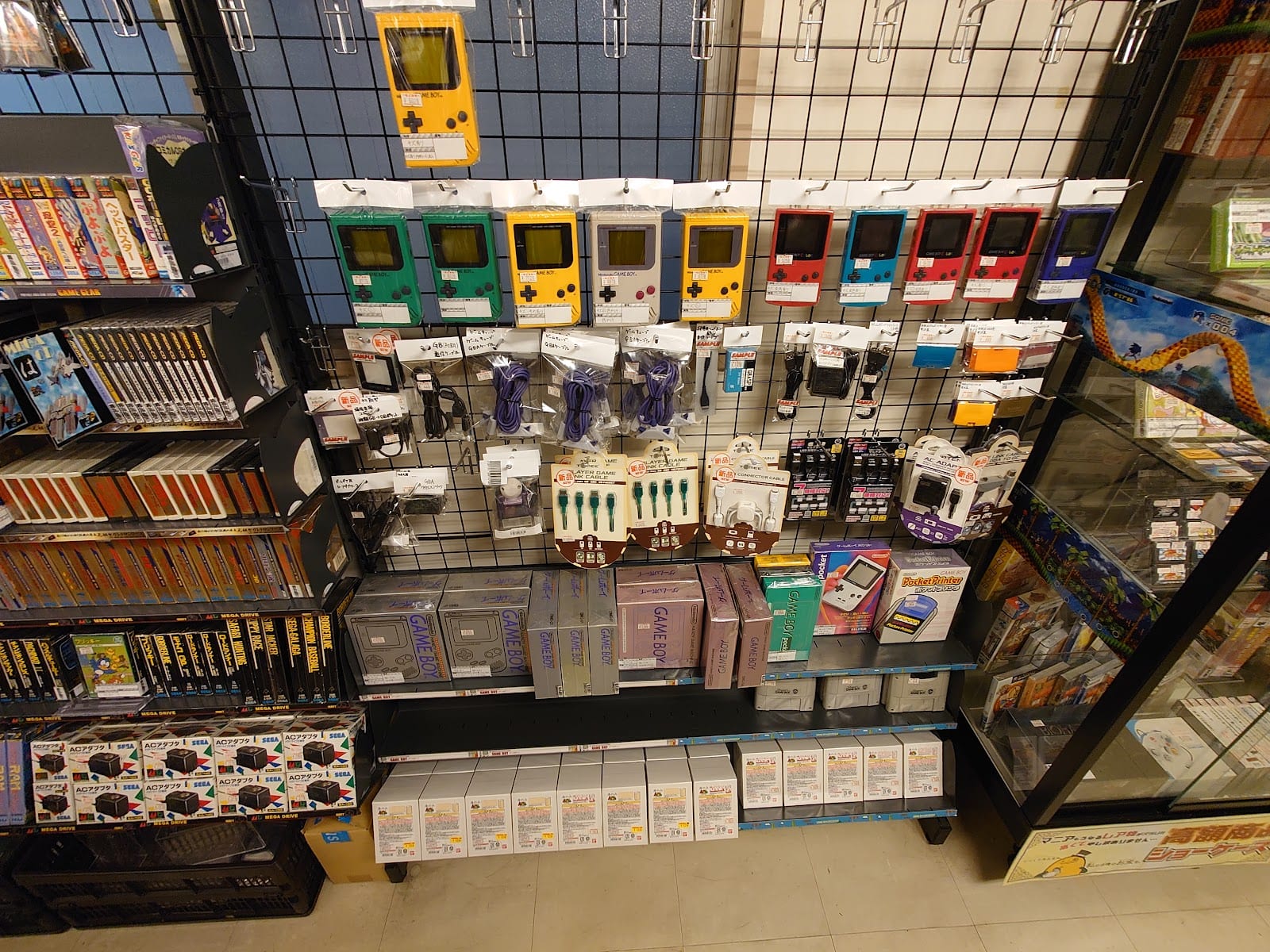 Cases of vintage handheld consoles at Super Potato.