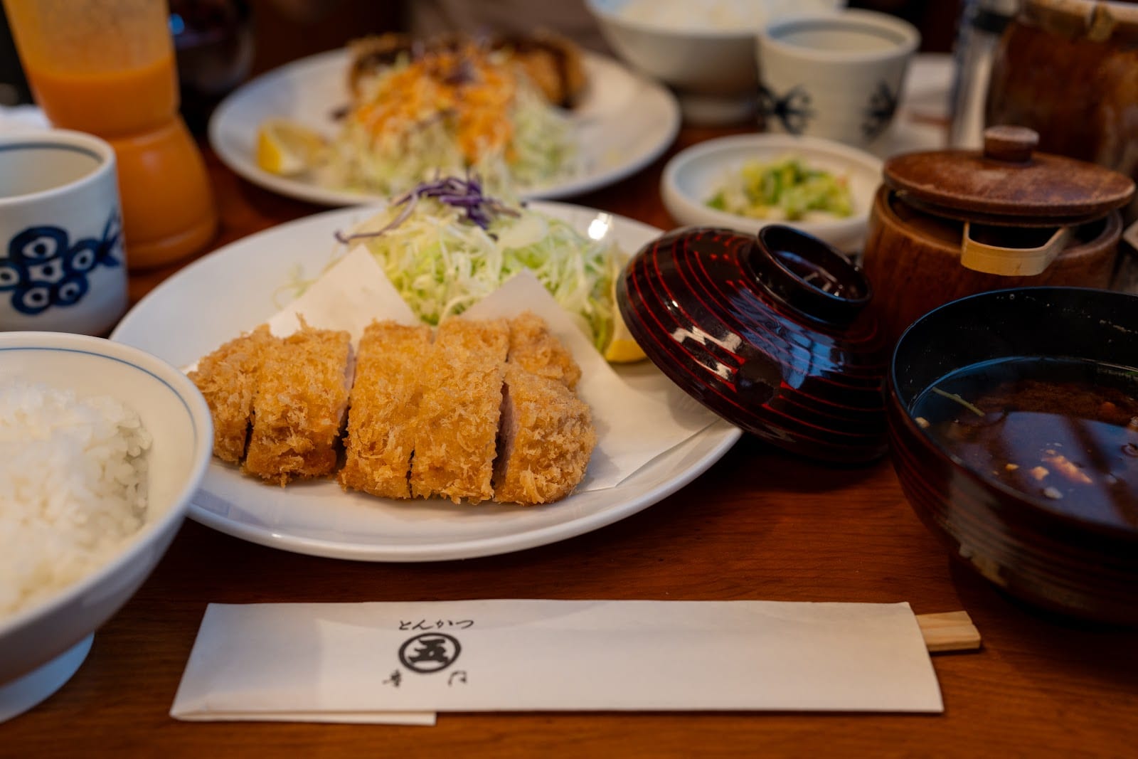 A tonkatsu set meal with rice, miso soup, and cabbage.