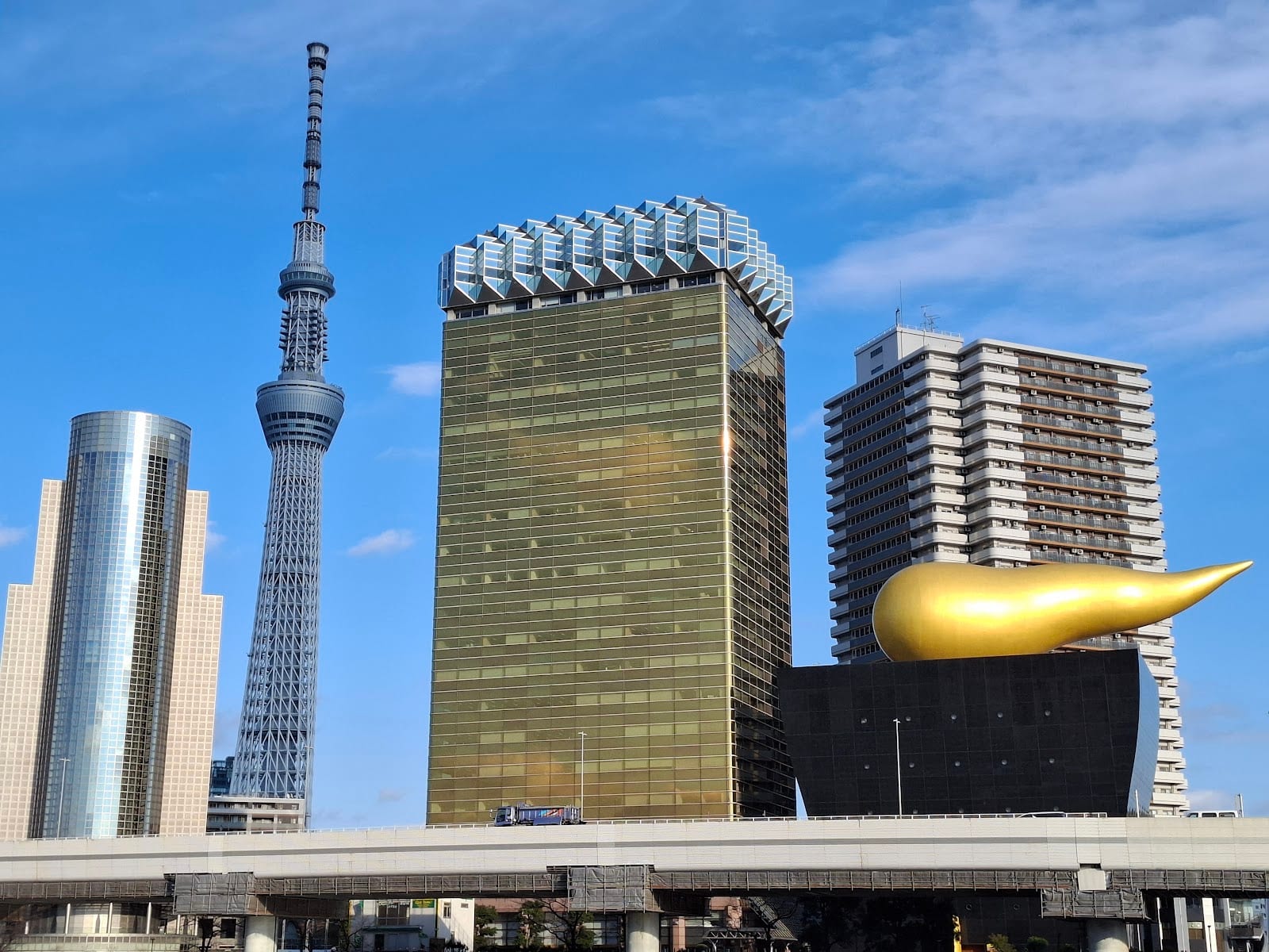 Tokyo Skytree and the golden Asahi Beer Hall across the Sumida River.