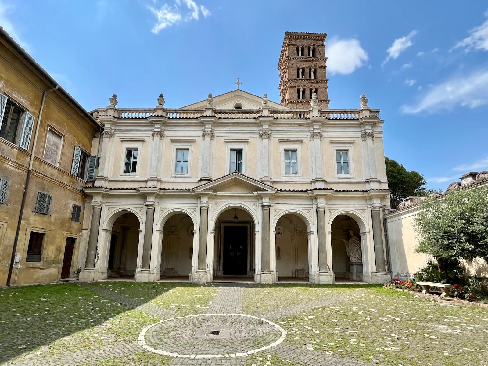 The facade, courtyard and Romanesque bell tower of Santi Bonifacio e Alessio.