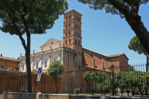 The 13th-century Romanesque campanile of Sant'Alessio framed by umbrella pines.