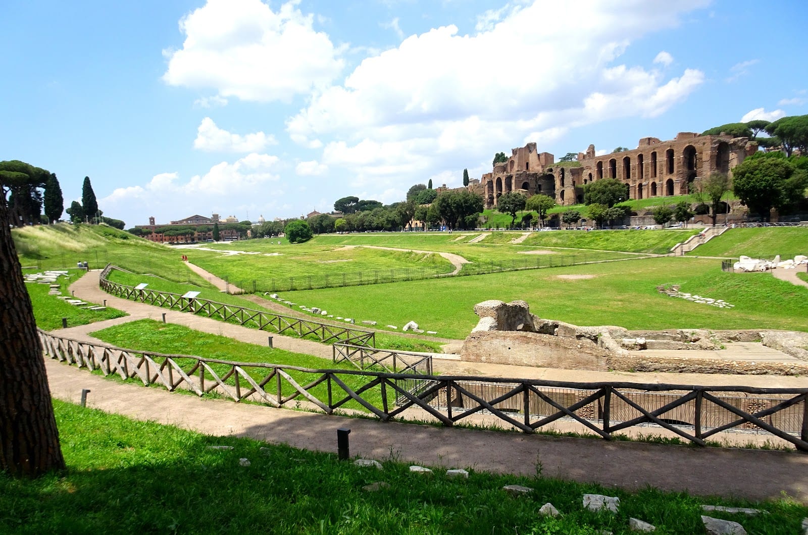 The green expanse of the Circus Maximus under a blue Roman sky.