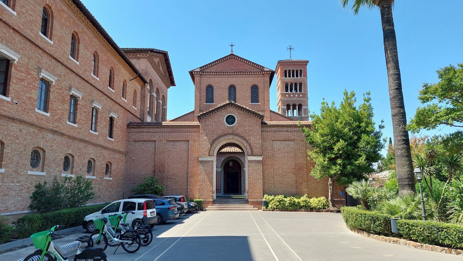 The brick facade and forecourt of the Benedictine church of Sant'Anselmo.