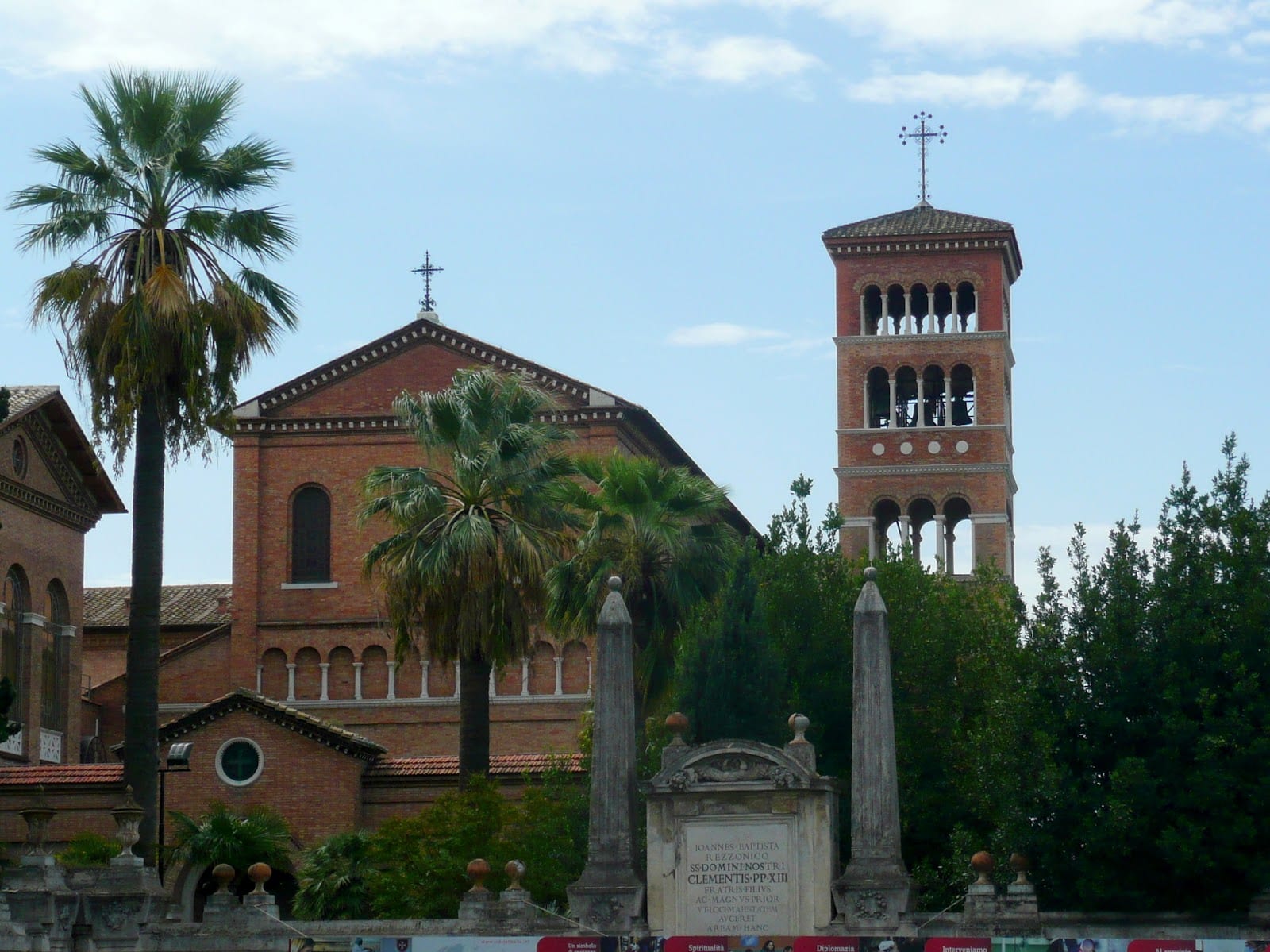 The bell tower of Sant'Anselmo framed by palms on the Aventine.