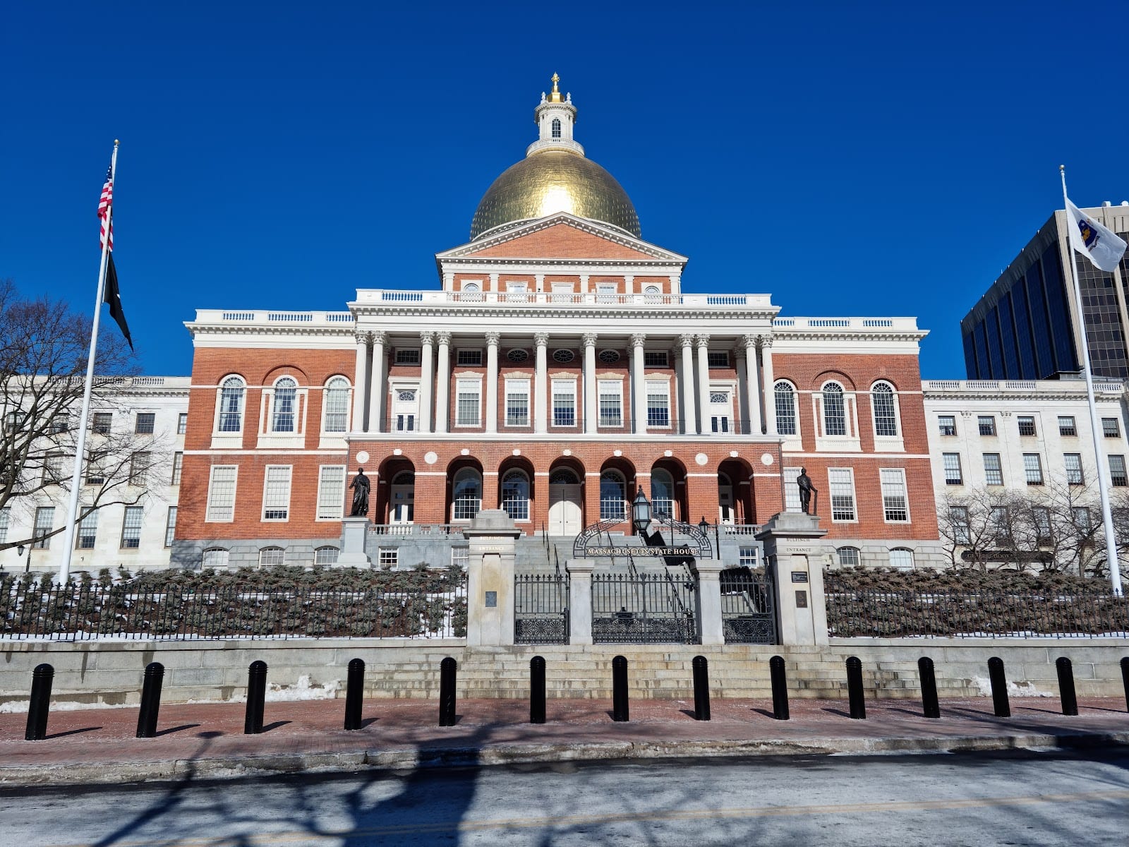 The gold dome of the Massachusetts State House above Beacon Hill rooftops.