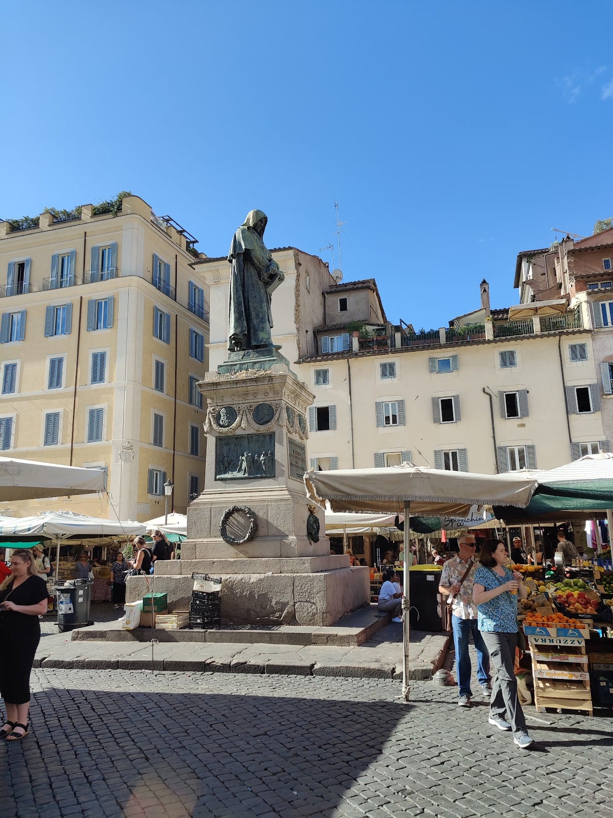 The statue of Giordano Bruno and market stalls on Campo de' Fiori.