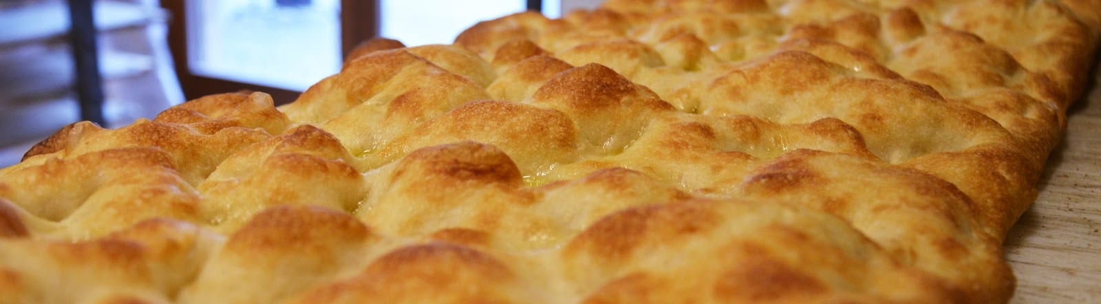 A tray of Rome's dimpled pizza bianca at Forno Campo de' Fiori.