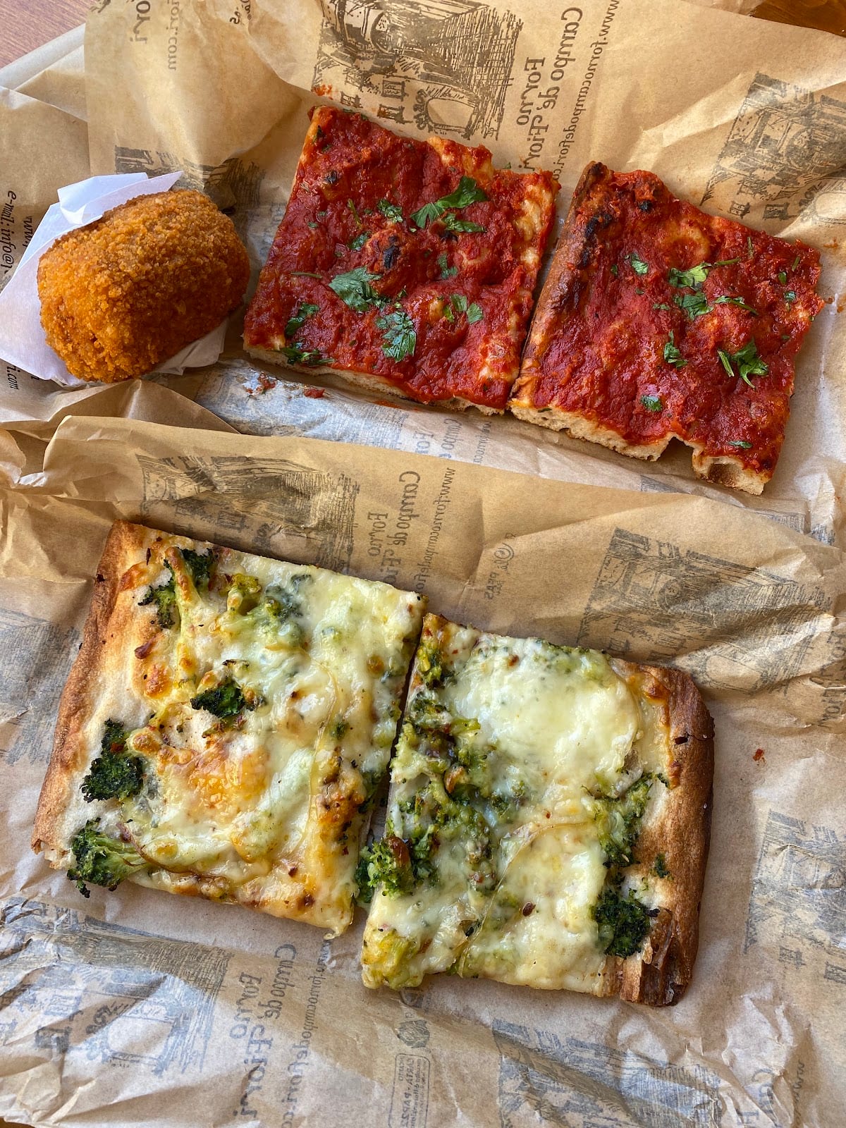 Slices of pizza rossa and topped pizza al taglio at Forno Campo de' Fiori.