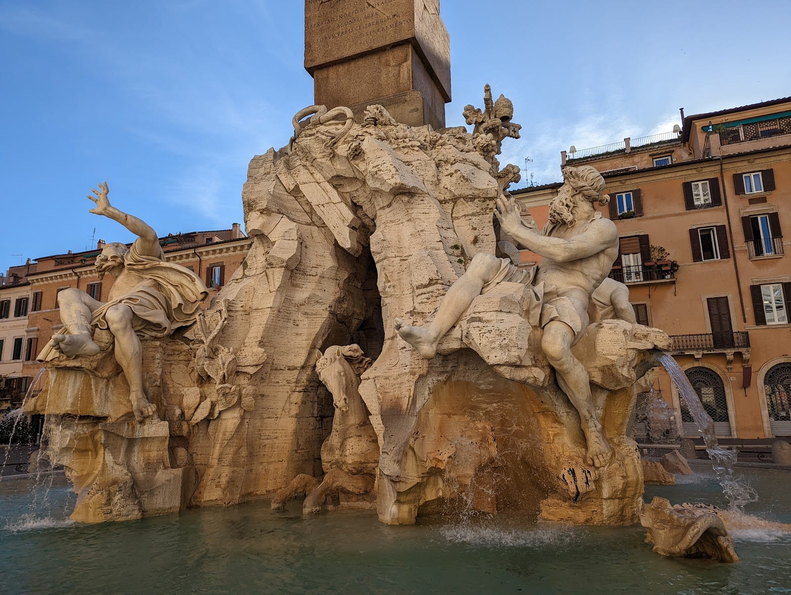 Bernini's Fountain of the Four Rivers with its river gods and obelisk on Piazza Navona.