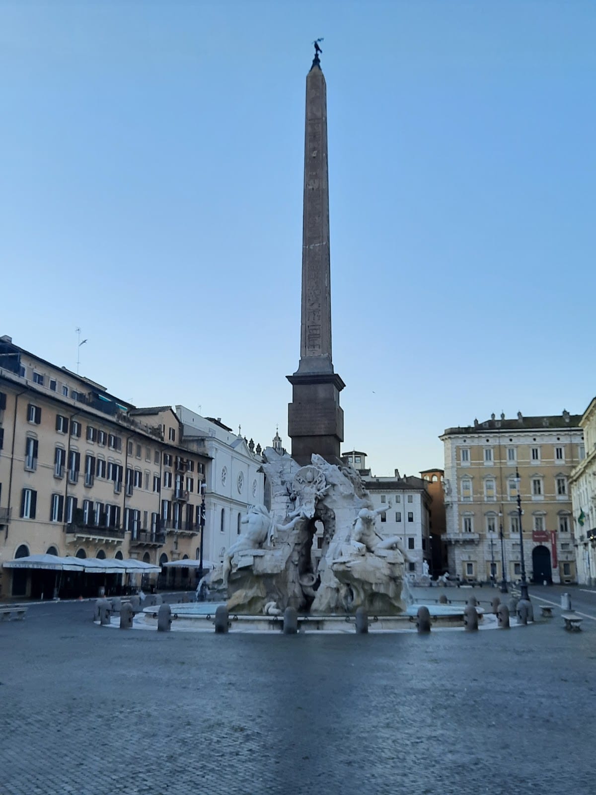 The obelisk and Four Rivers fountain on the oval of Piazza Navona.