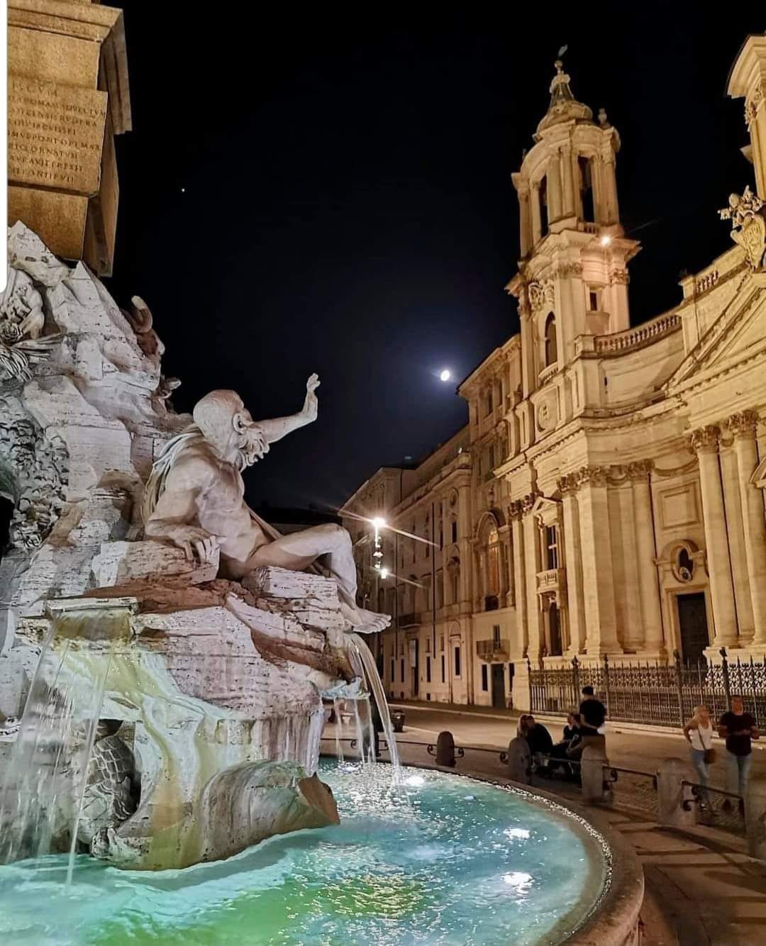 The Four Rivers fountain and Sant'Agnese in Agone on Piazza Navona at night.