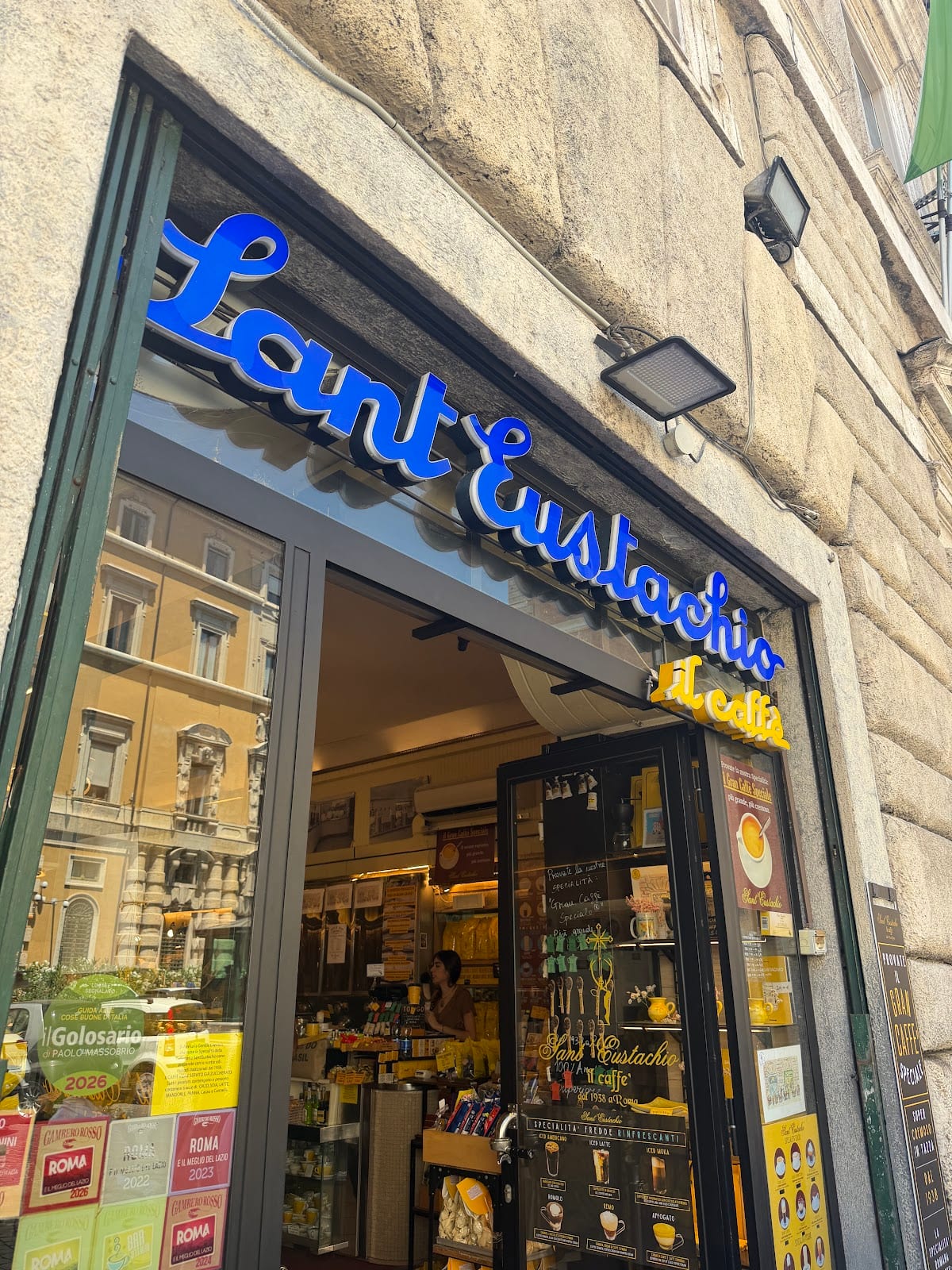 The blue neon sign of Sant'Eustachio Il Caffè.