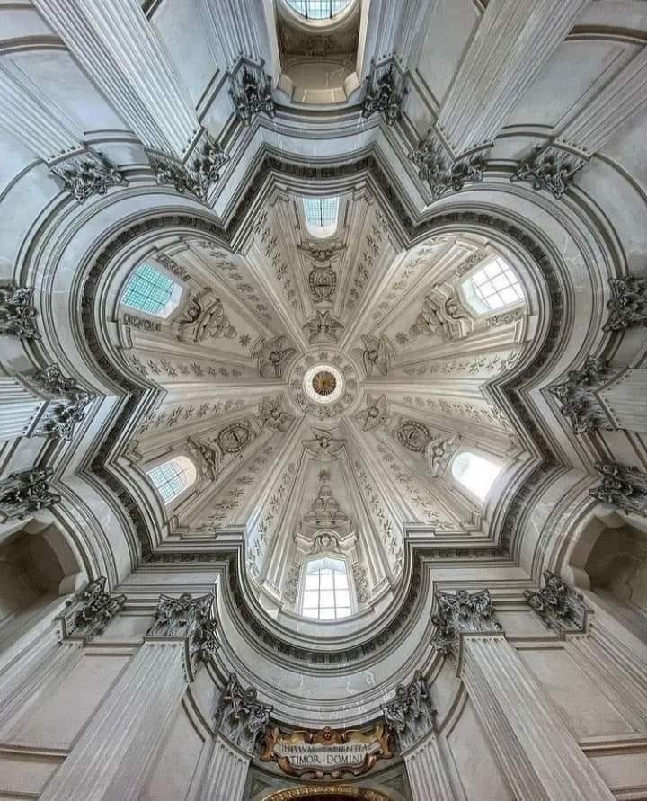 The white star-plan dome of Sant'Ivo alla Sapienza seen from below.