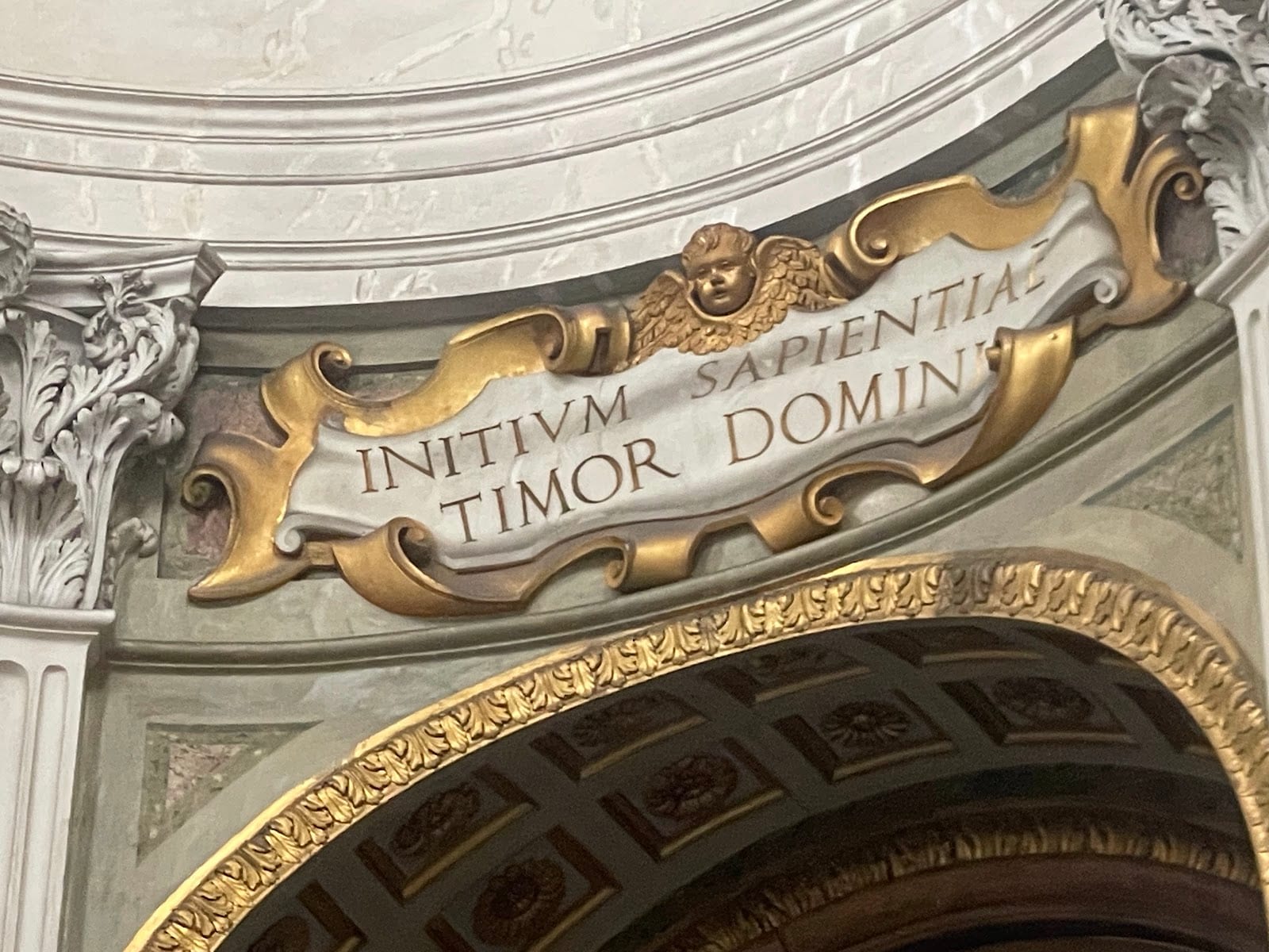 The gilded inscription band beneath the dome of Sant'Ivo alla Sapienza.