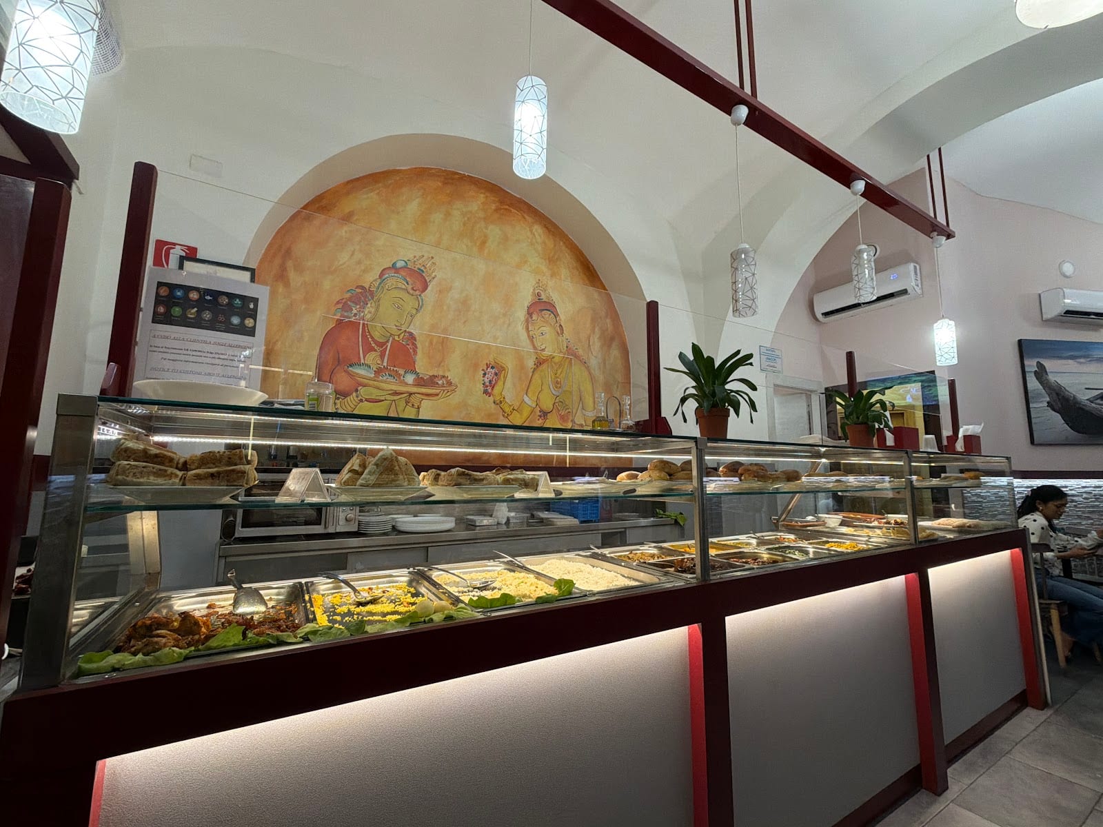 The casual interior and food counter of 7 Seven Lanka in the Esquilino.
