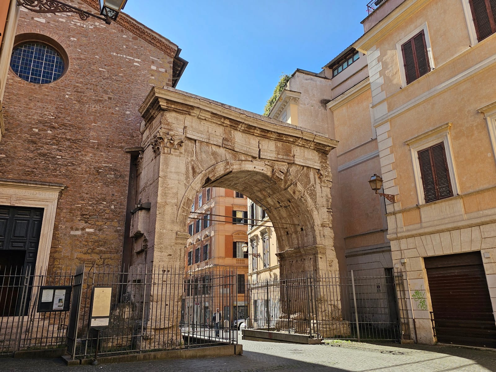 The single travertine Arch of Gallienus beside the church of Santi Vito e Modesto in Rome.