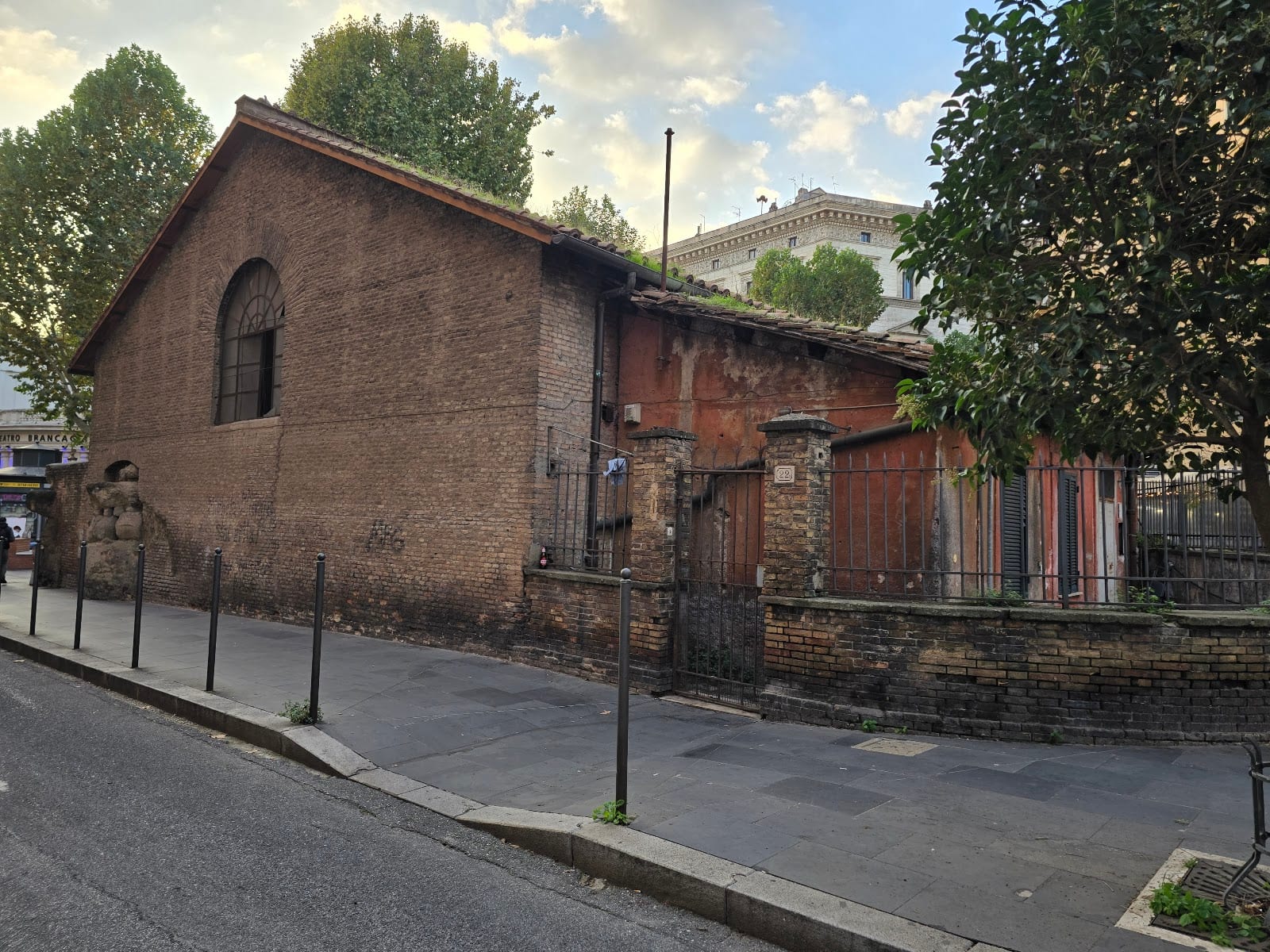 The brick exterior of the Auditorium of Maecenas on a street corner in the Esquilino.