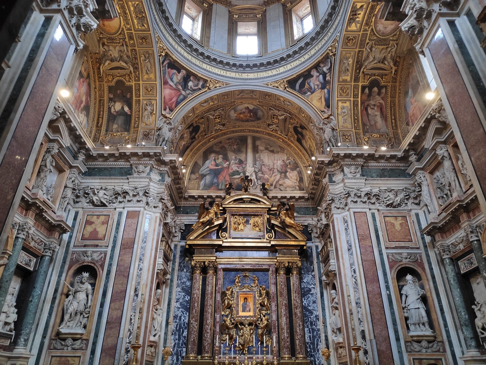 An ornate frescoed and gilded side chapel inside Santa Maria Maggiore.