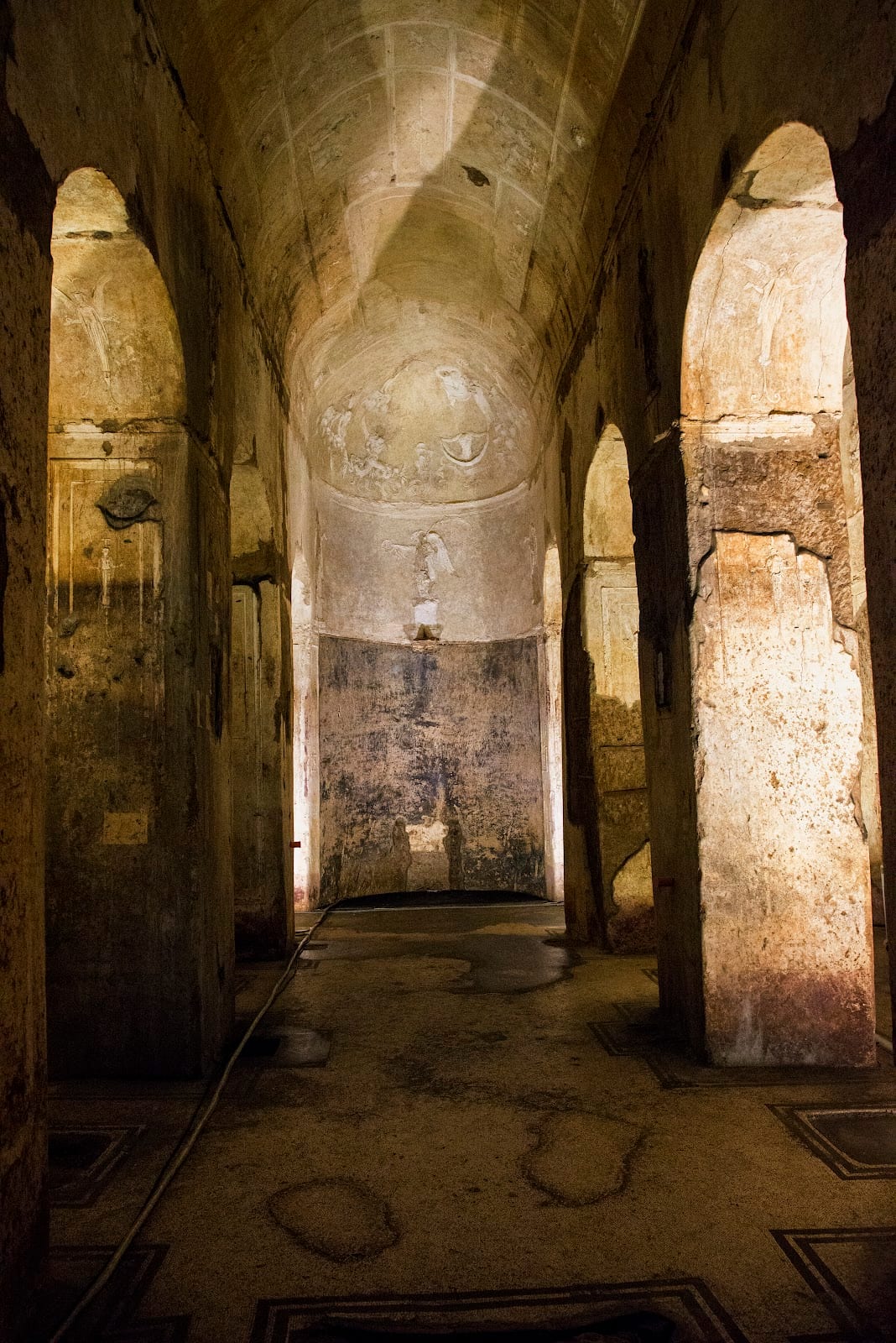 The stuccoed apse and nave of the underground Basilica of Porta Maggiore in Rome.