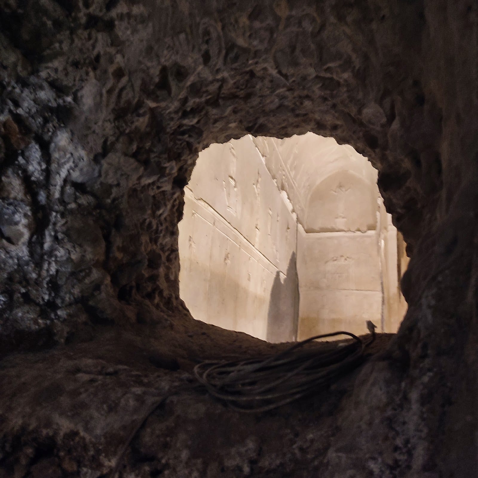 A view into the white-stuccoed underground chamber of the Basilica of Porta Maggiore.