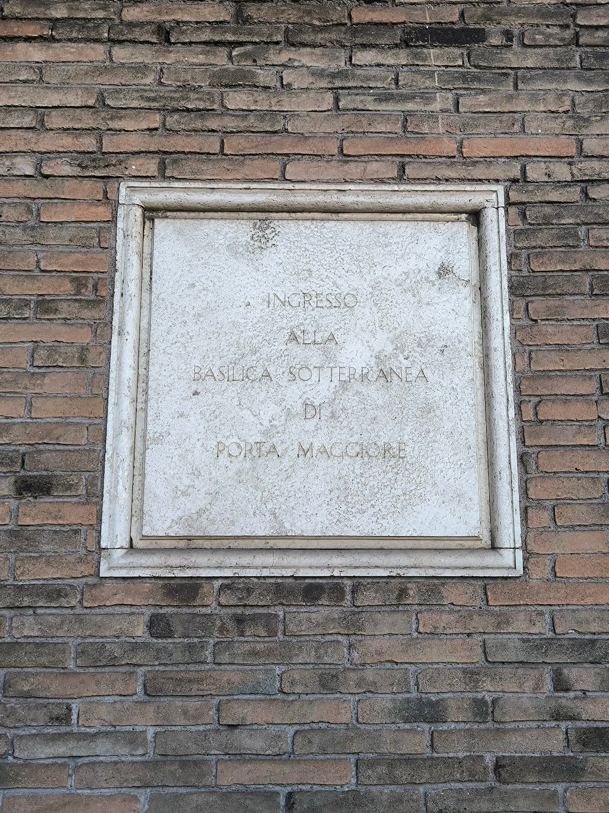 The carved entrance sign to the Basilica Sotterranea di Porta Maggiore.