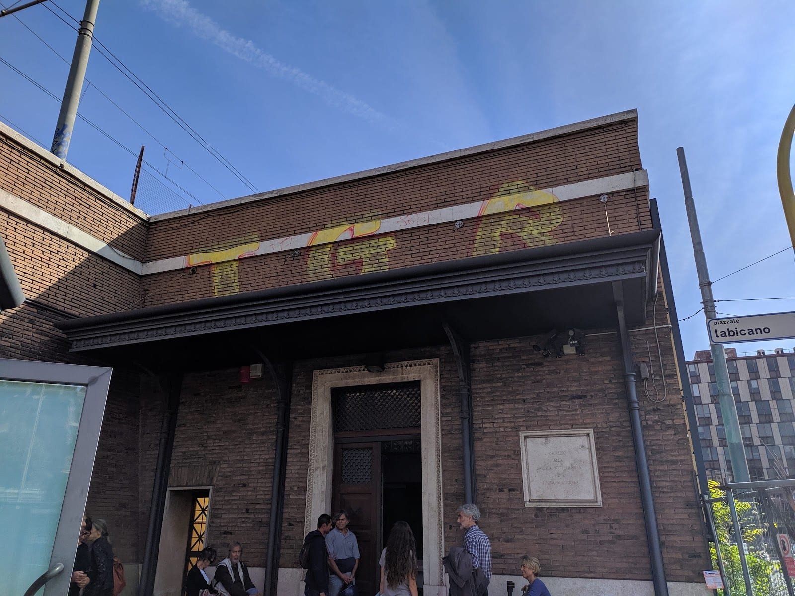 Visitors at the modern entrance pavilion to the underground Basilica of Porta Maggiore.