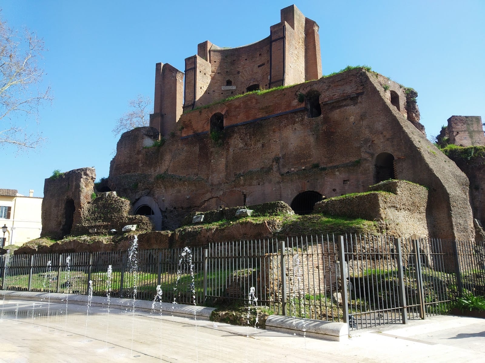 The ancient Trofei di Mario fountain ruin behind the fountains of the Piazza Vittorio garden.
