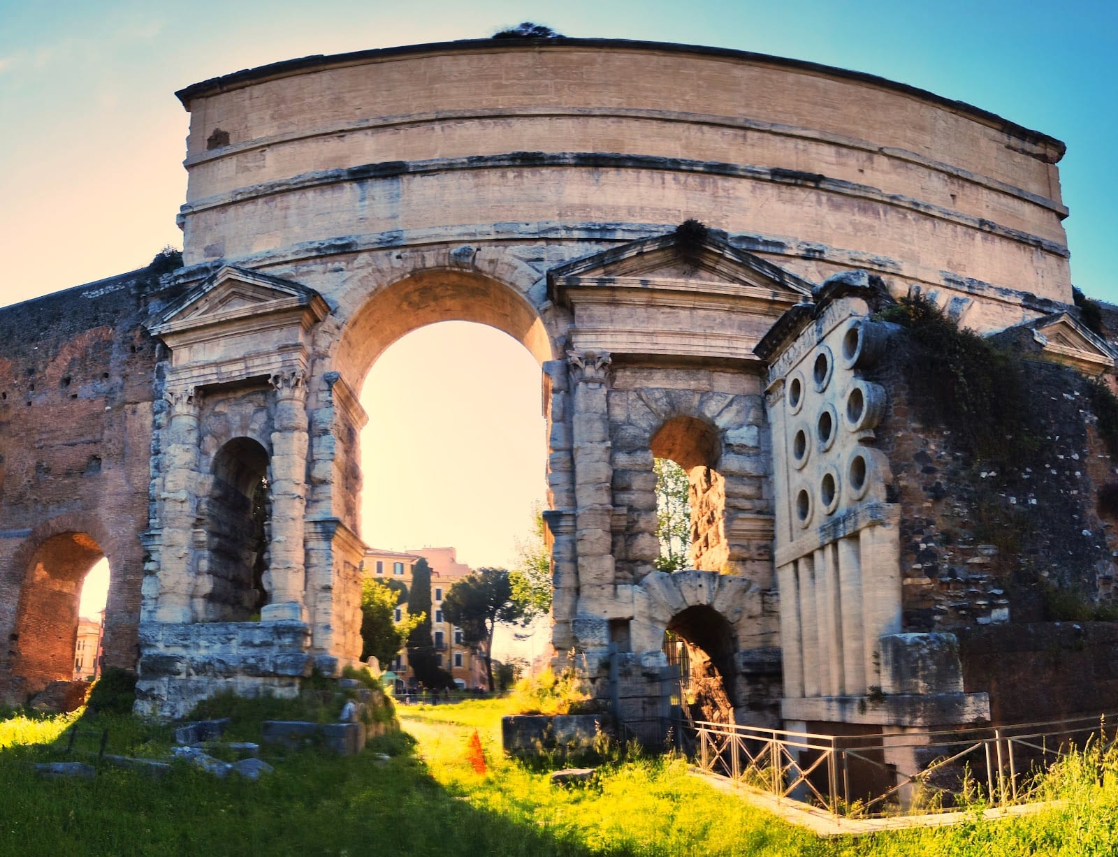 Porta Maggiore and the round-windowed Tomb of Eurysaces the Baker at golden hour.