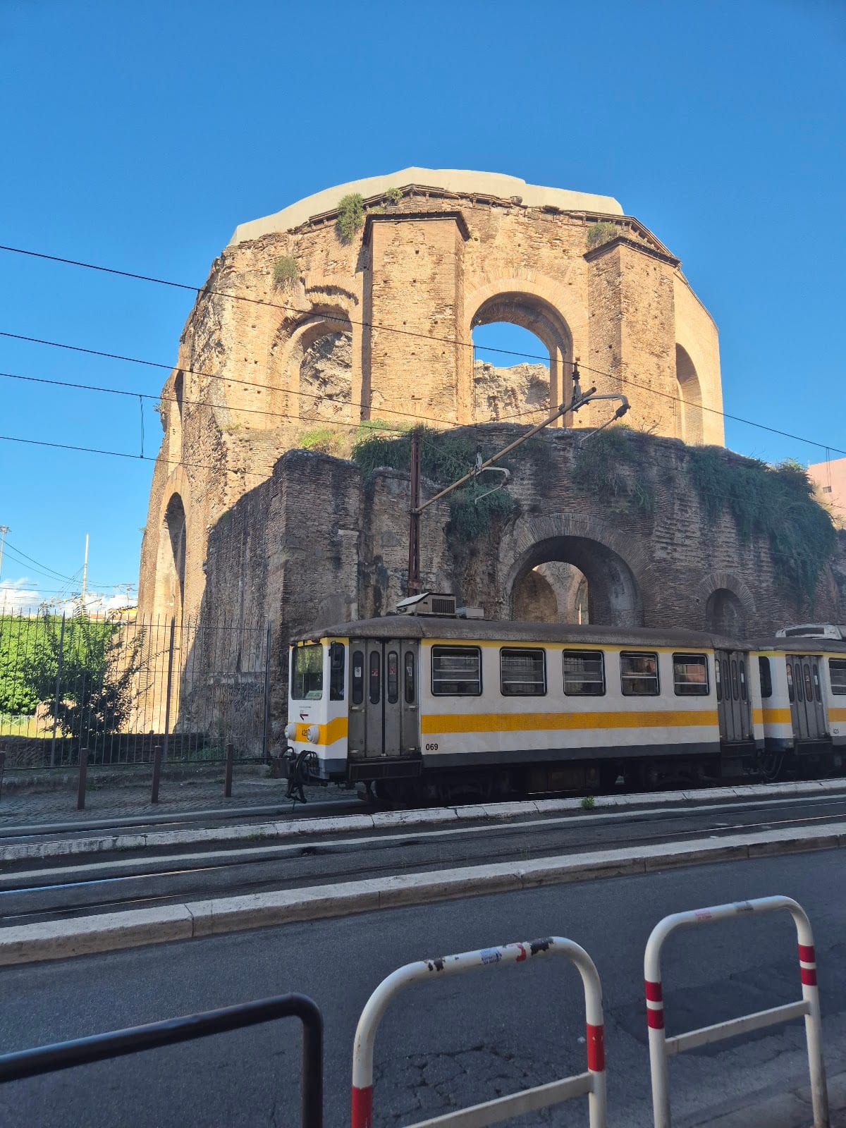 The ruined dome of the Temple of Minerva Medica beside the tram lines in Rome.