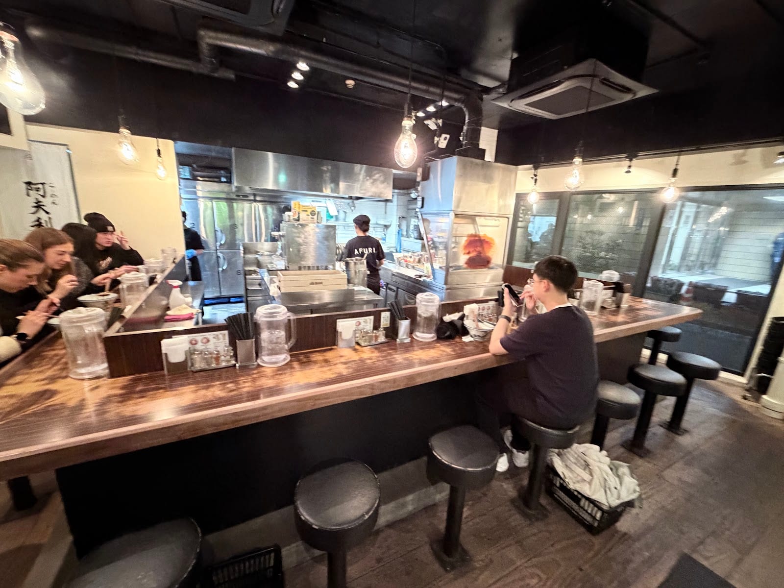 Diners at the counter inside AFURI Harajuku.