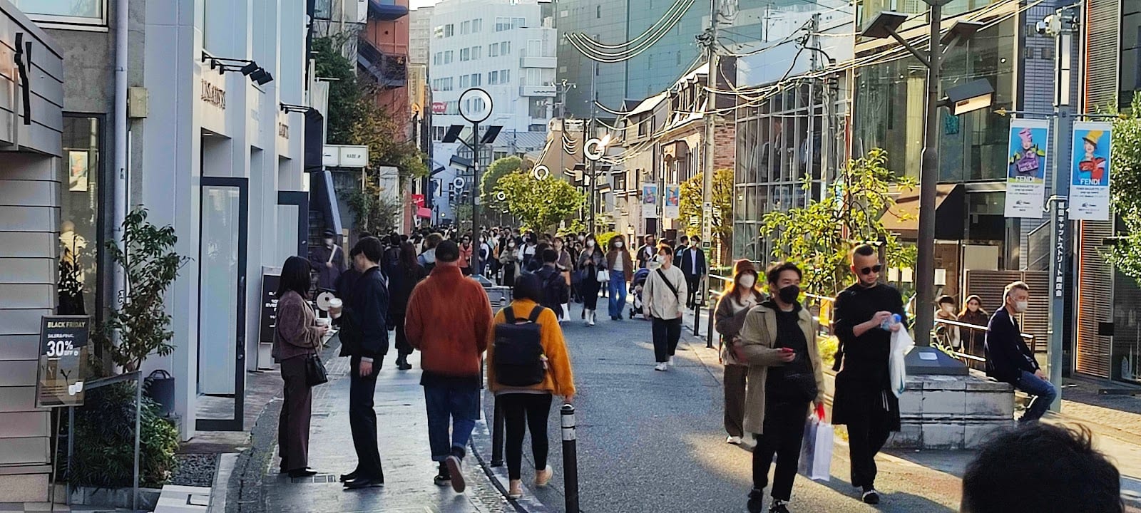 Shoppers along the low-rise boutiques of Cat Street.