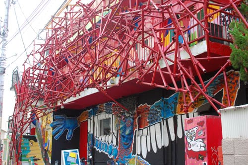 Pipe-and-mural art on a Design Festa Gallery building.