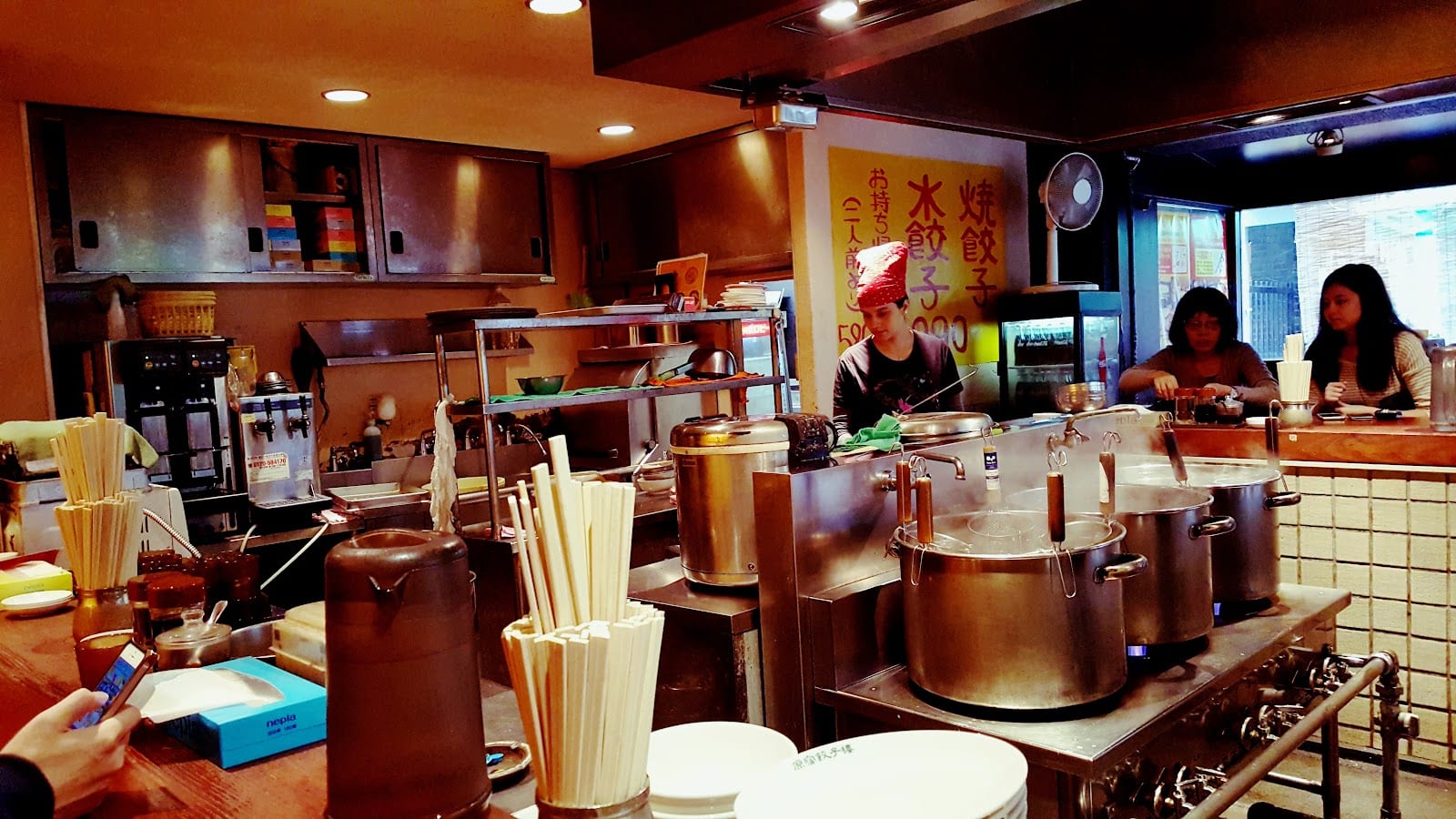 The counter and open kitchen at Harajuku Gyozaro.