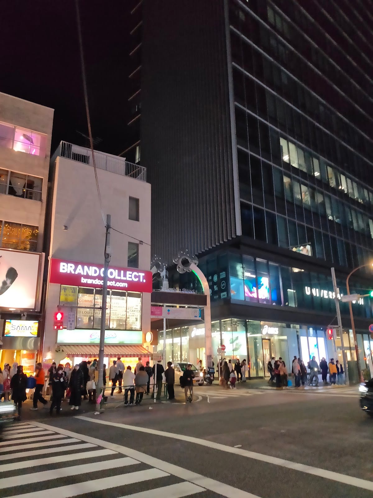 Crowds and signage along Takeshita Street after dark.
