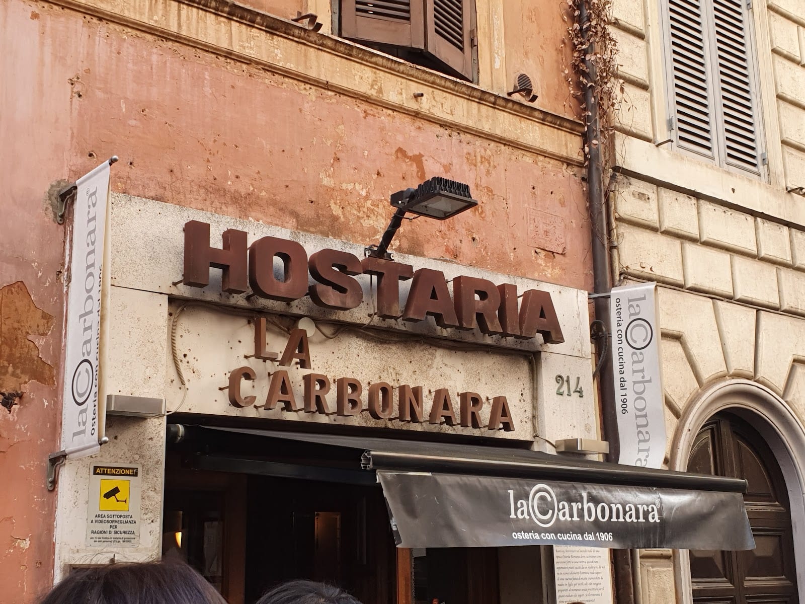 The storefront of Hostaria La Carbonara on Via Panisperna in Monti.