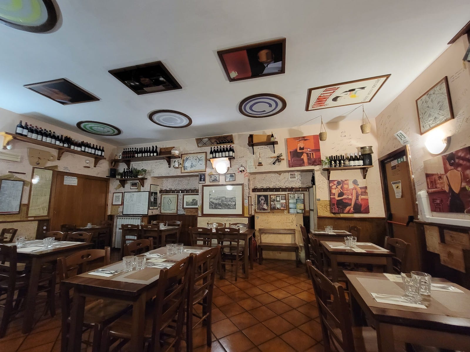 The traditional dining room of La Carbonara, hung with framed photos.