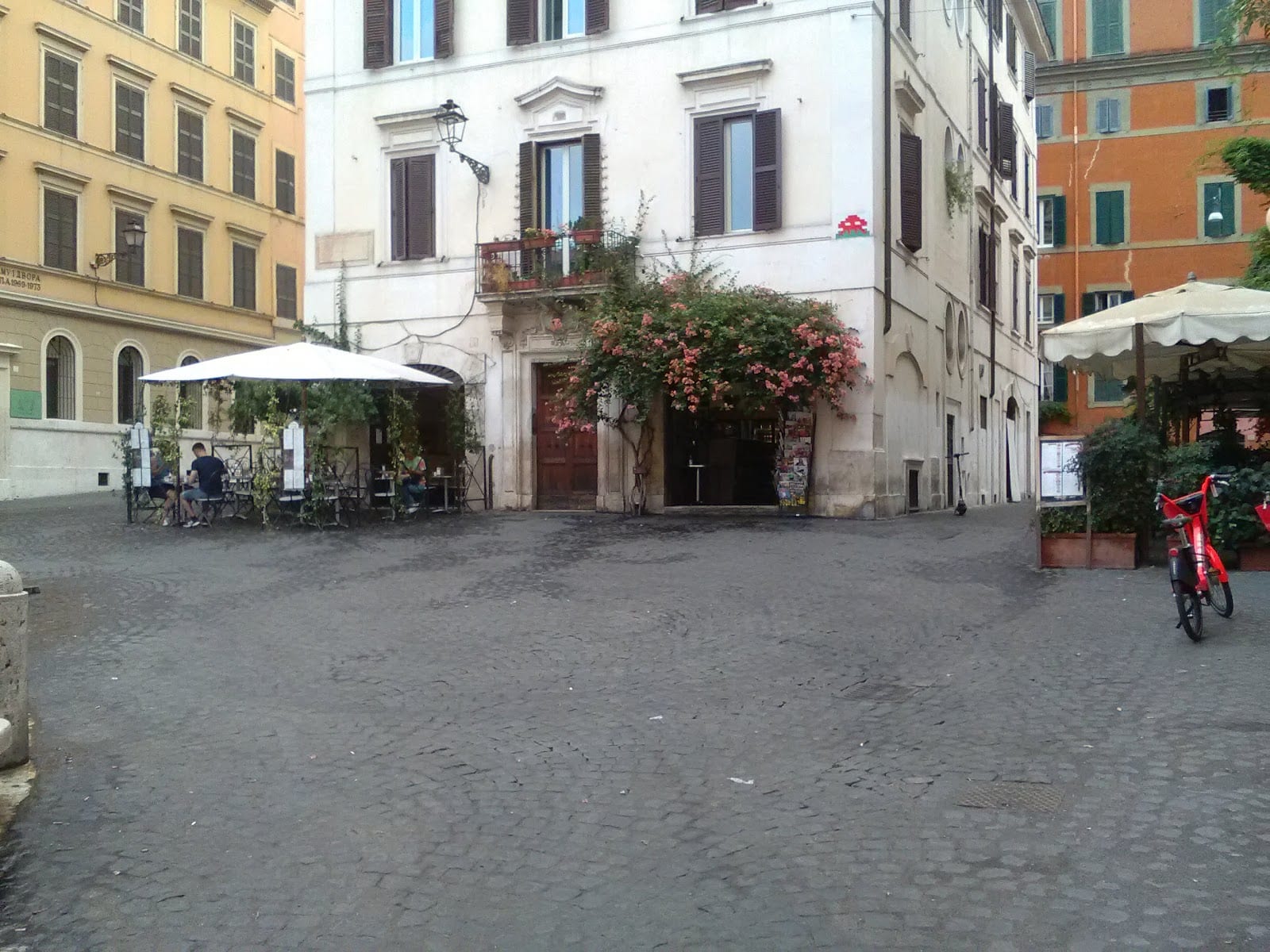 Cafe tables and umbrellas on Piazza della Madonna dei Monti.