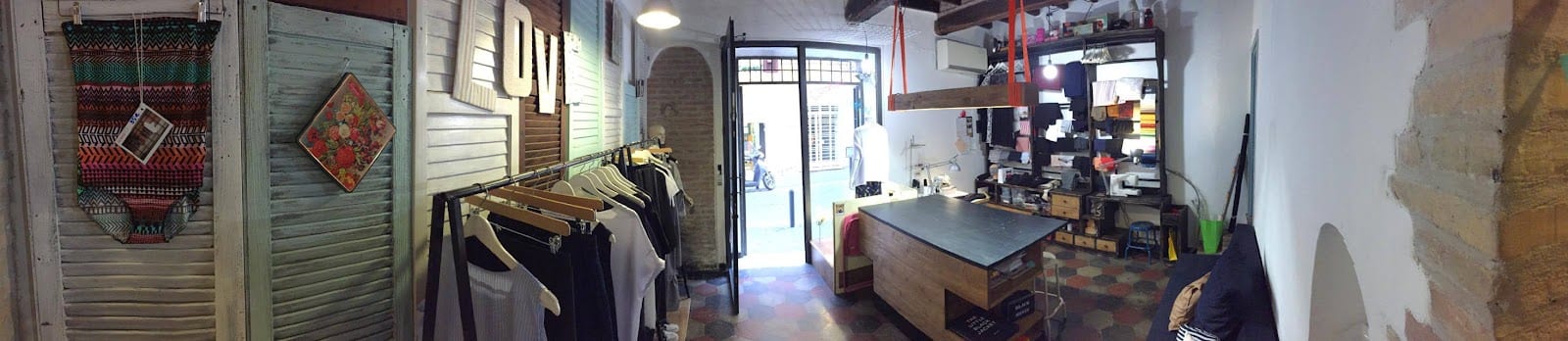 An artisan boutique with its door open onto a Monti backstreet.