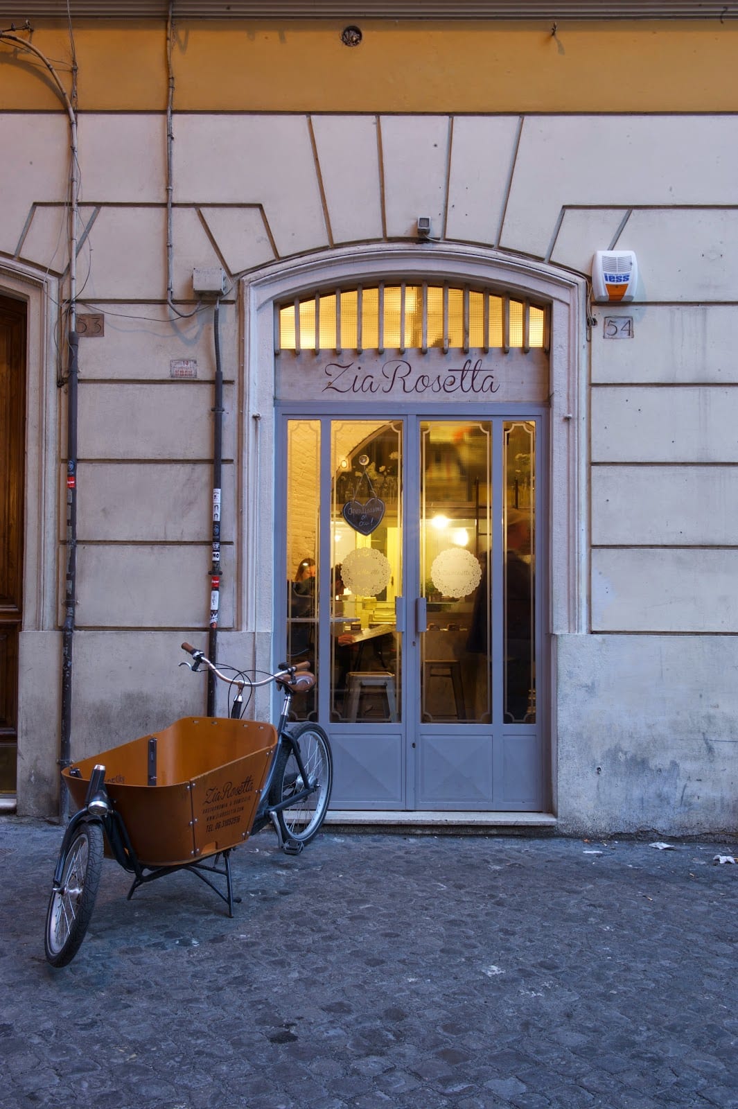 The warm-lit storefront of Zia Rosetta in Monti, Rome.