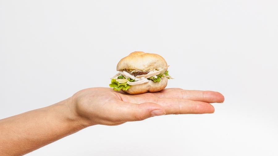 Zia Rosetta's signature small rosetta sandwich held in hand.
