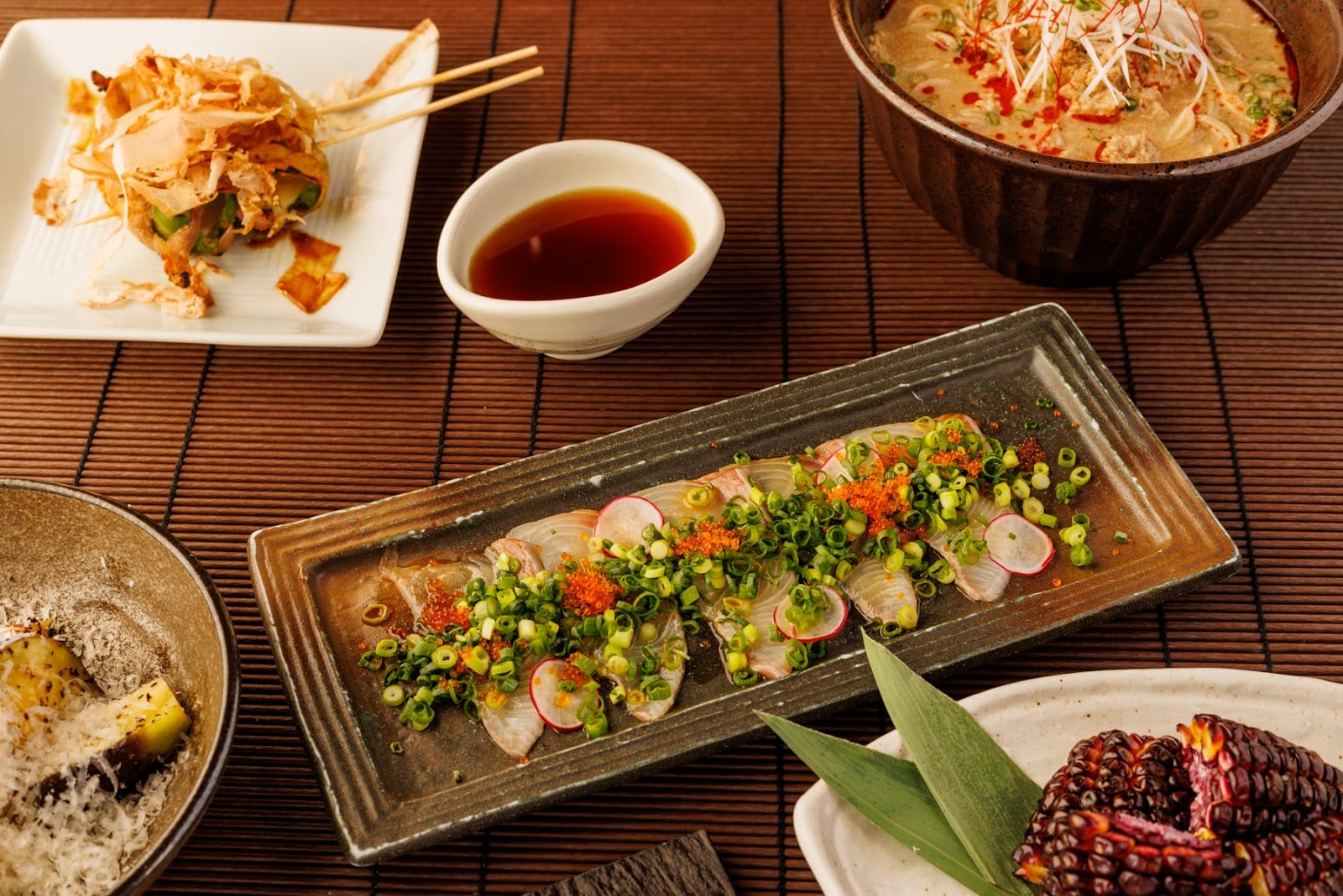 A long platter of sashimi and small dishes at Gonpachi.