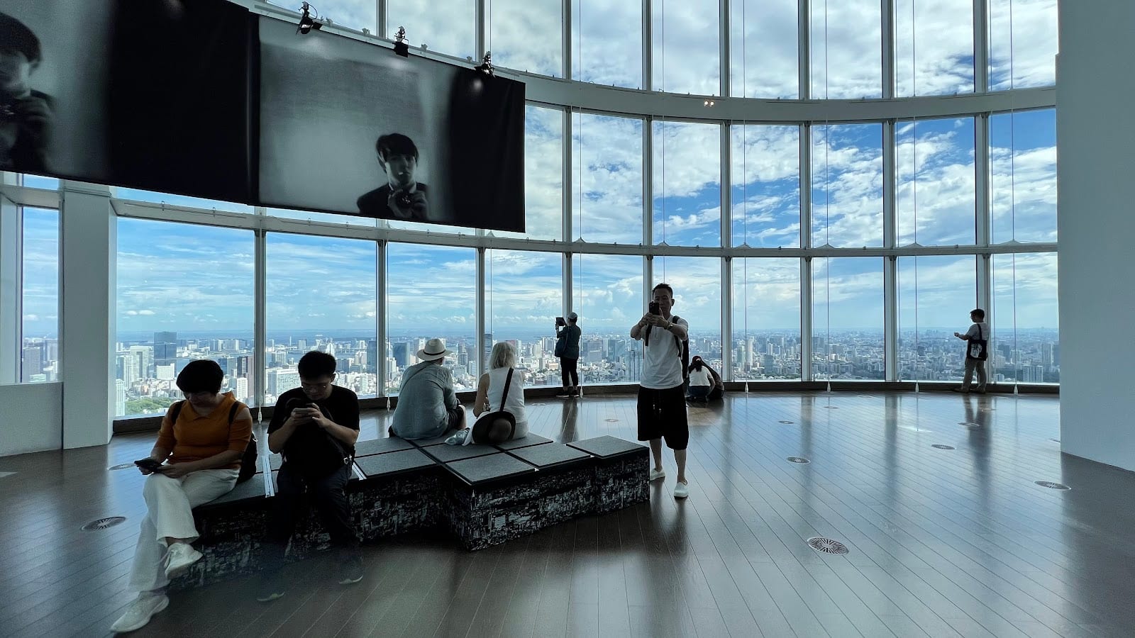 Visitors at the floor-to-ceiling windows of Tokyo City View.