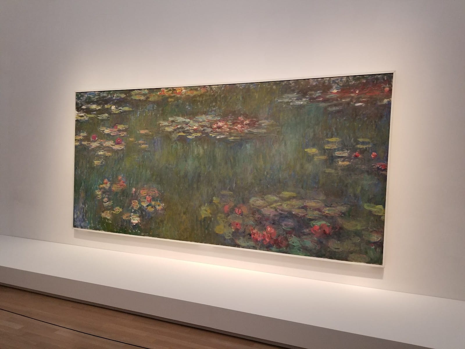 A large painting on a white gallery wall at the National Art Center.