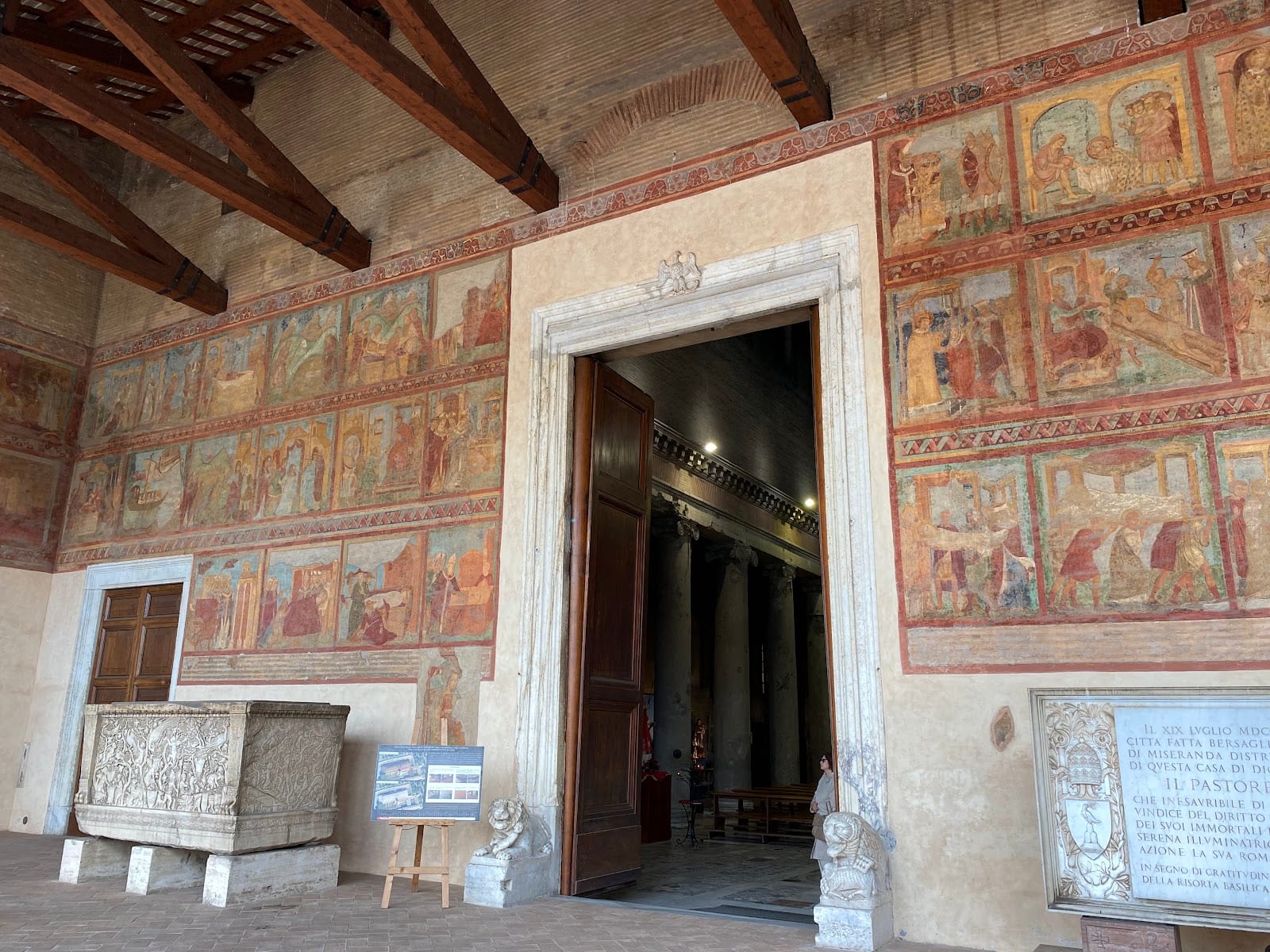 Frescoes and an ancient sarcophagus in the portico of San Lorenzo fuori le Mura.