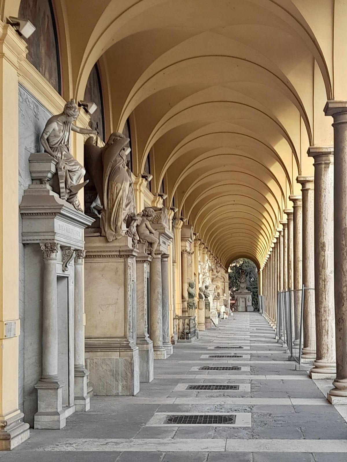 An arcaded gallery lined with funerary sculpture at Campo Verano.